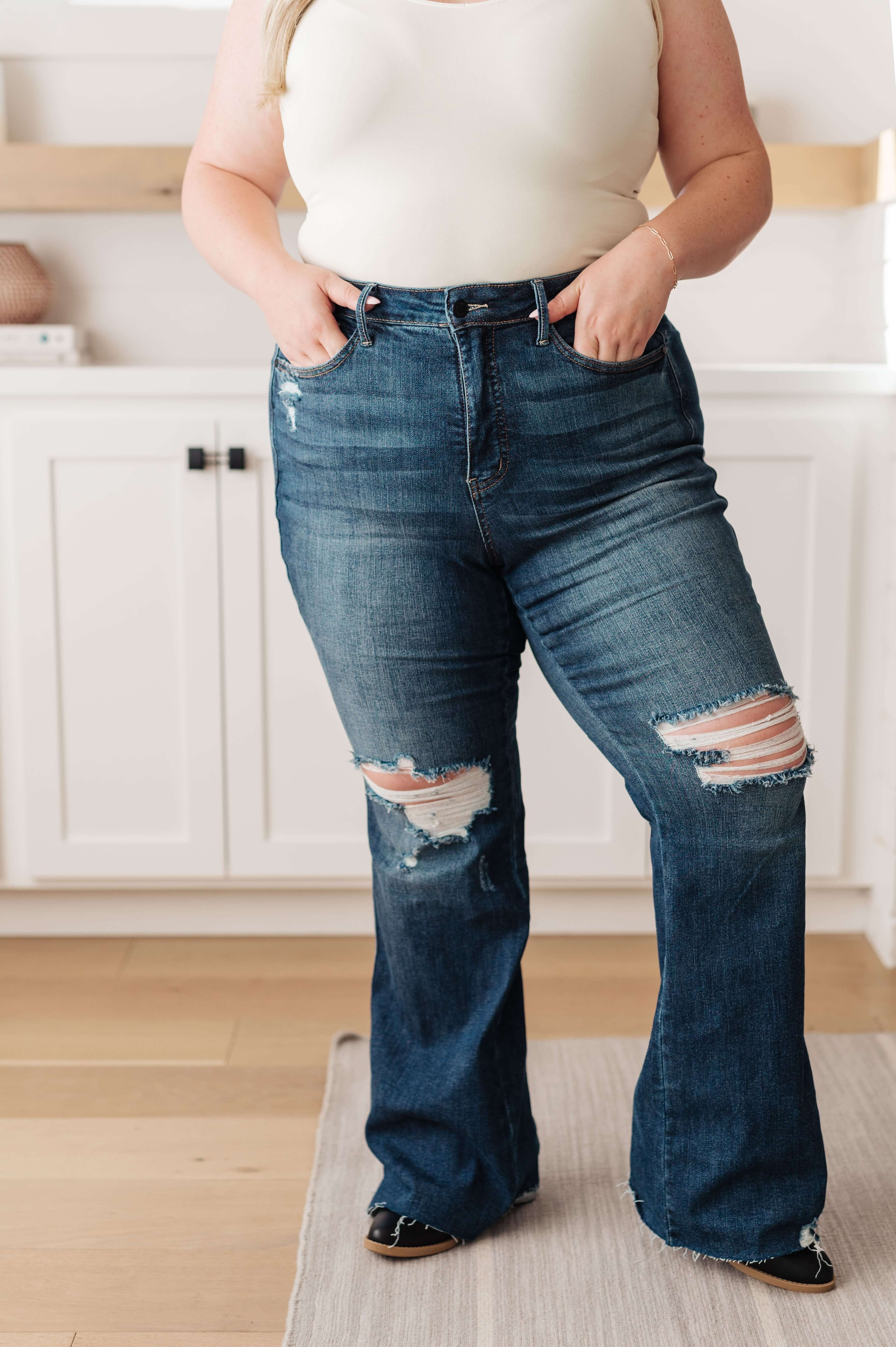 Woman wearing Judy Blue jeans with distressed details, showcasing a perfect fit and comfortable style.